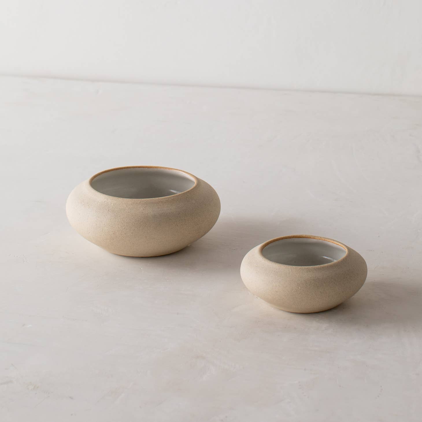 convivial ikebana no 2 vase / Slow down and enjoy the subtle beauty of nature with a handmade ceramic ikebana vase. This round, shallow vase is designed for minimal, ikebana inspired arrangements. Handmade with proprietary sandstone with an ivory glaze on the interior.
