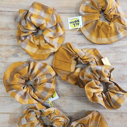 Plaid scrunchies, made from leftover scraps from All Road's textile production.