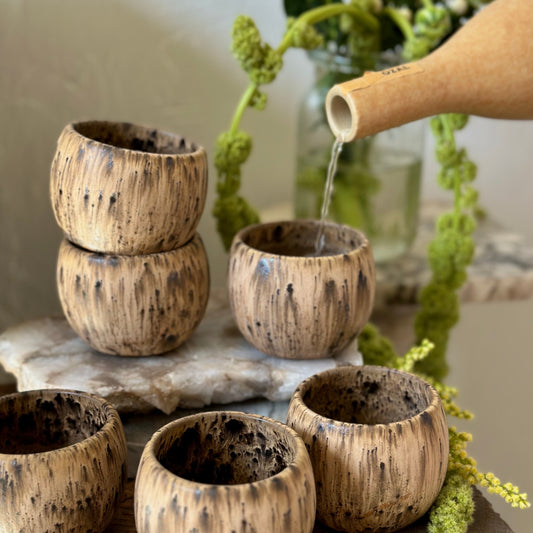 Ideal for sipping mezcal, espresso, or sake, the Lil Sipper is designed to fit perfectly in your hand. Each piece is handmade in small batches from a rich brown clay, then finished with an earthy glaze featuring bold speckles and soft, reactive edges.