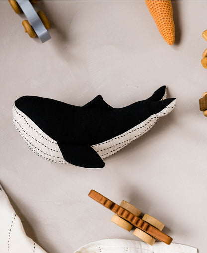 Adorable and eco-friendly stuffed whale features kantha-stitched details and is hand-made from upcycled scrap fabric pieces.