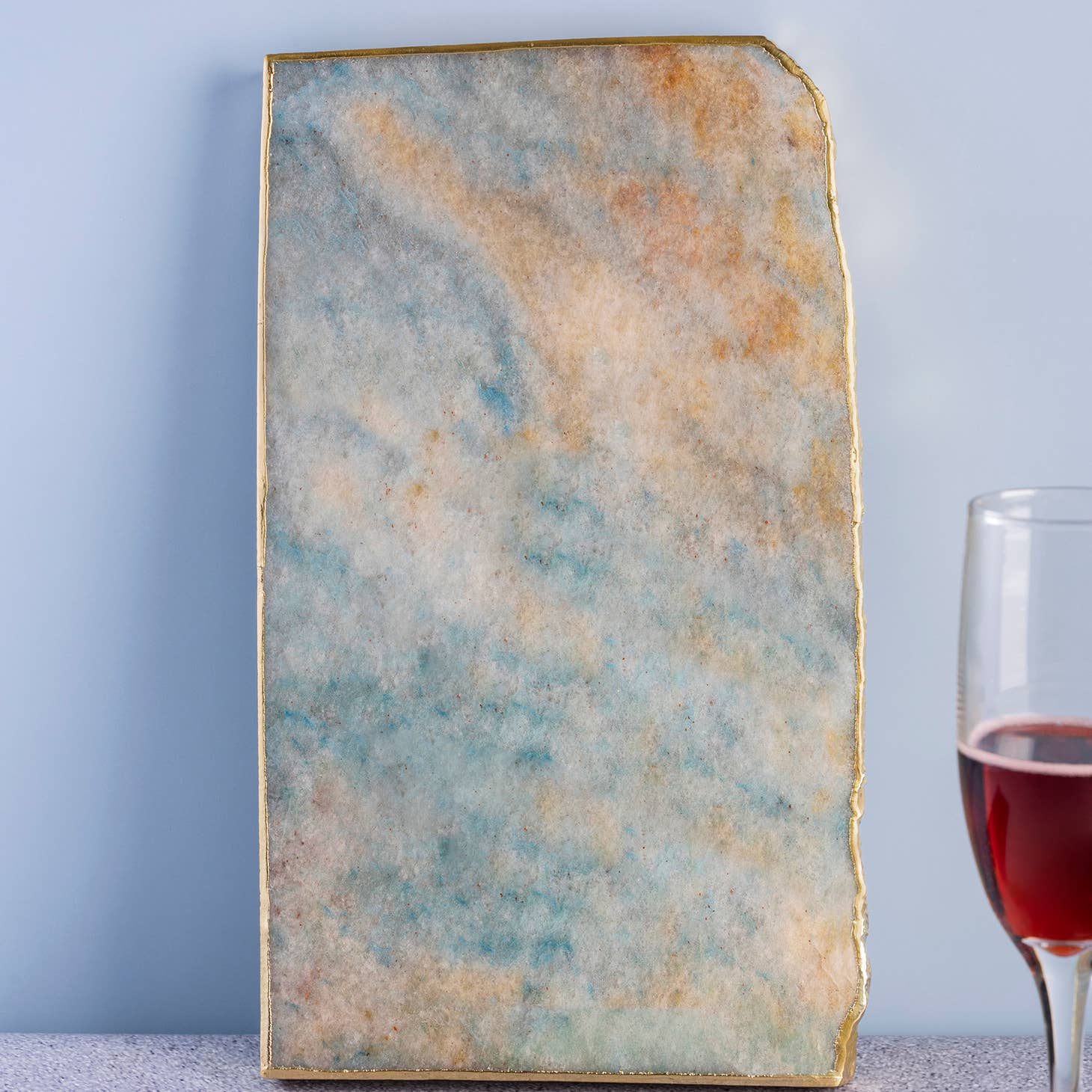 Suitable for use at both formal and informal occasions, this handcrafted aventurine cheese board is gilded with gold edges, & the perfect size to serve an array of options. made in india