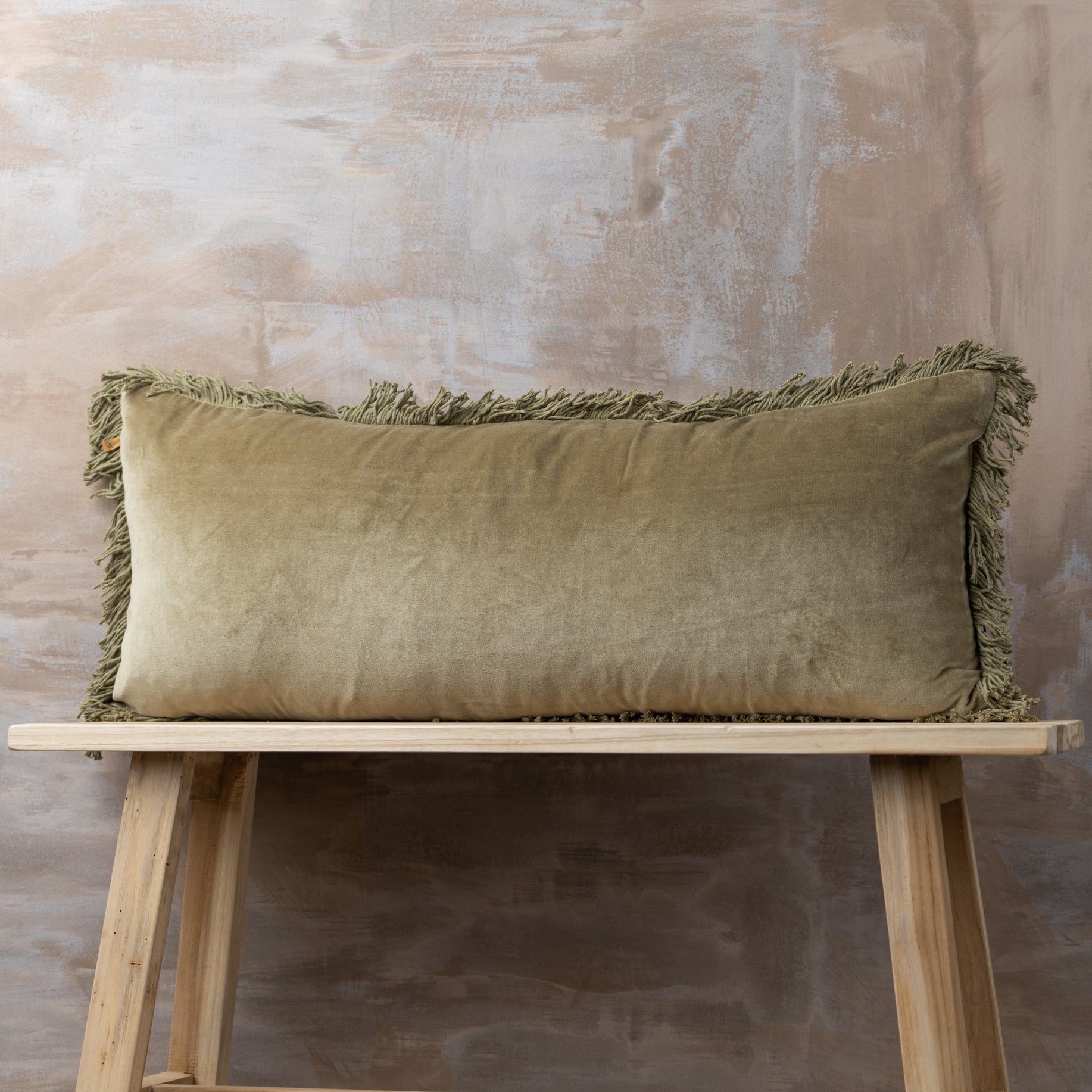 The Olive Velvet Bolster Cushion is the epitome of relaxed, retro styling. With super soft, with vintage wash tones and frayed edge detail, it adds an understated luxury to your room. Made with 100% cotton, measures 15.75" x 35.43".