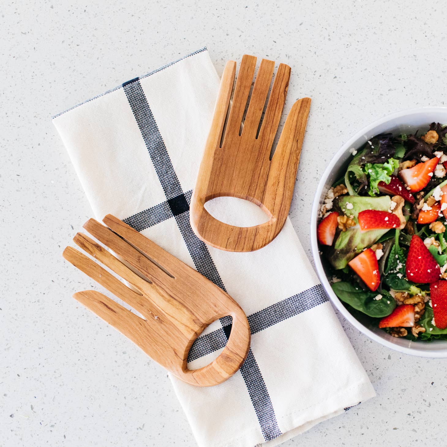 These serving hands are perfect for salads & shaped from durable olive wood. Wild olivewood has a rich grain and is indigenous to East Africa.   Ethically made in Kenya.