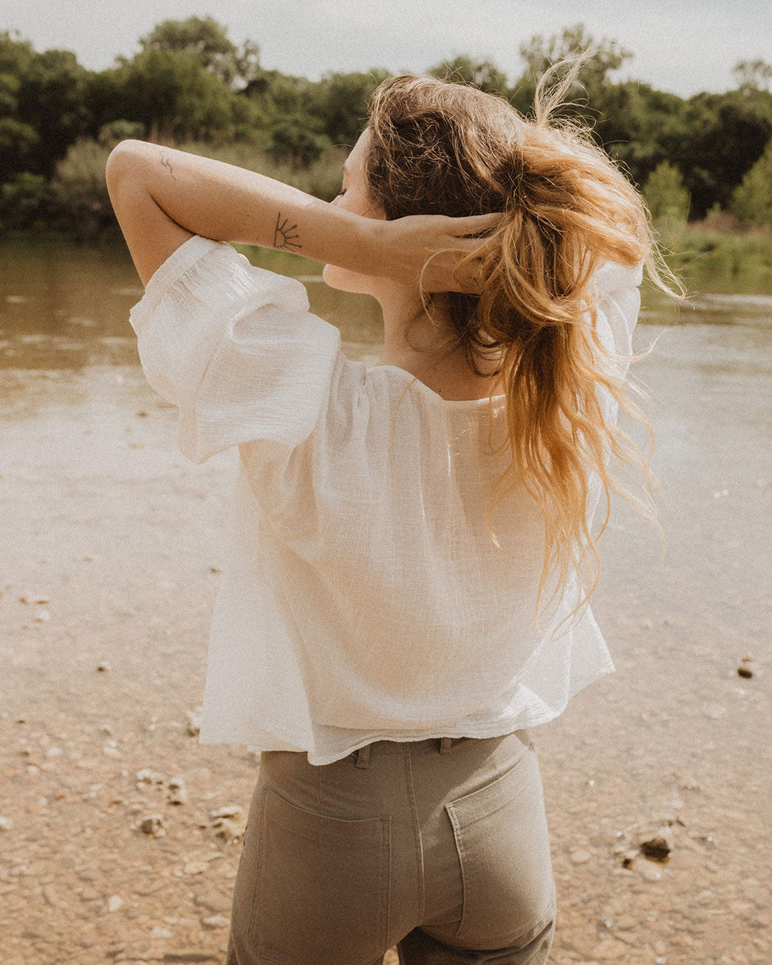This airy oversized top is inspired by our many tiered & flowing dresses. In true Esby fashion, the Mia is also reversible. Wear the gathered tiers & plunging neck in the front, or try the boat neck with a front tuck into your favorite jeans. Made with 100% cotton check gauze.