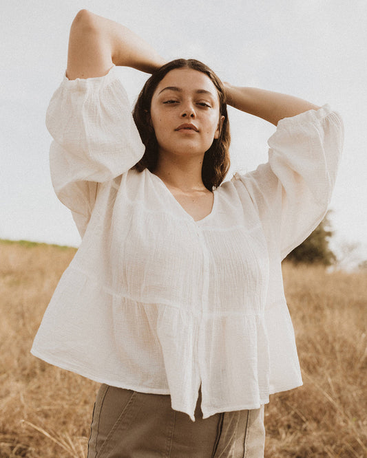 This airy oversized top is inspired by our many tiered & flowing dresses. In true Esby fashion, the Mia is also reversible. Wear the gathered tiers & plunging neck in the front, or try the boat neck with a front tuck into your favorite jeans. Made with 100% cotton check gauze.