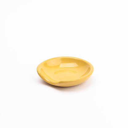  

A handmade stoneware spoon rest with a unique cut-out side perfectly cradles all shapes and sizes of kitchen tools with minimalist flair.
 