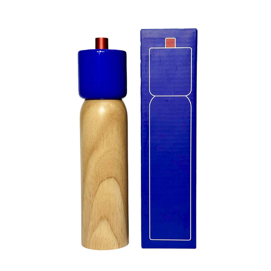 Wooden pepper grinder with blue top and packaging on a white background