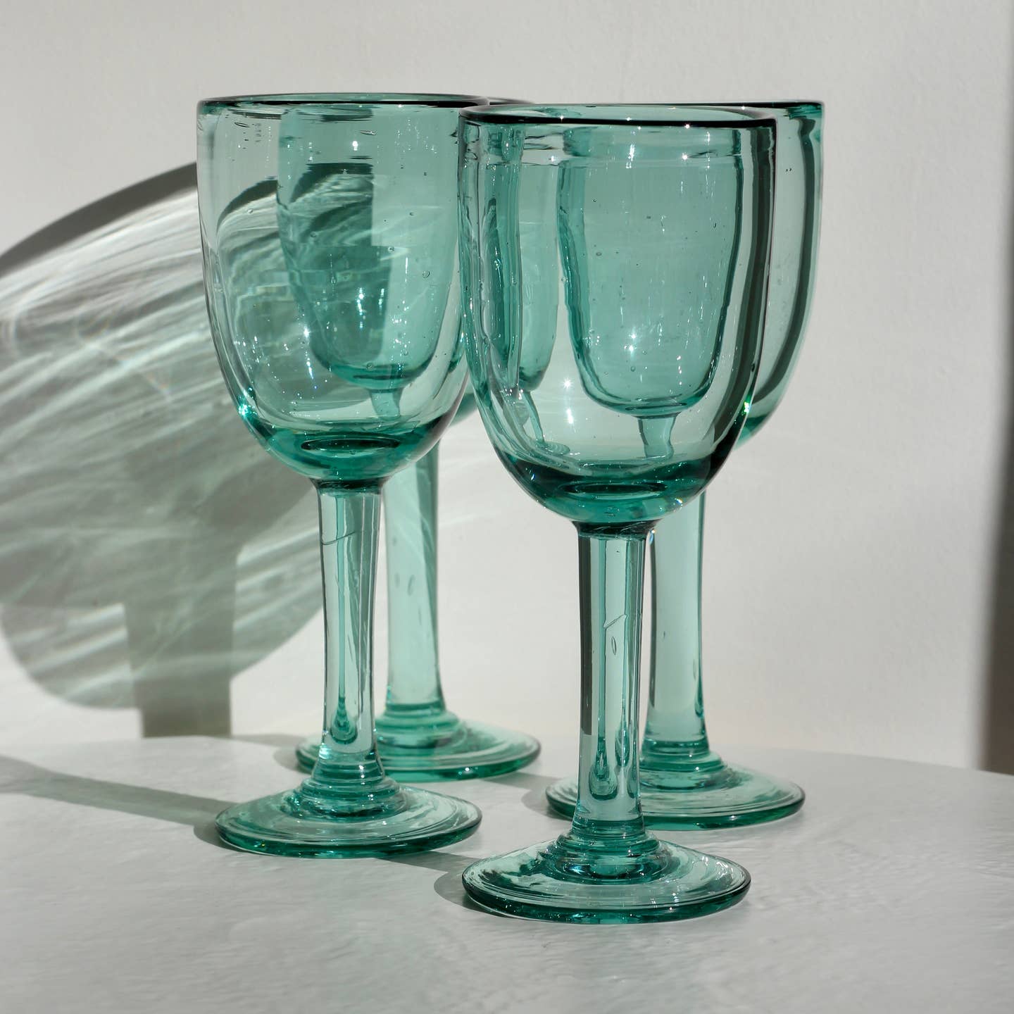 A funky, one-of-a-kind wine glass designed to bring character to any table. With its distinctive handmade feel, this stemmed glass adds a fun touch to serving wine. Each piece is handblown with recycled glass by artisan partners in Bogotá, Colombia.