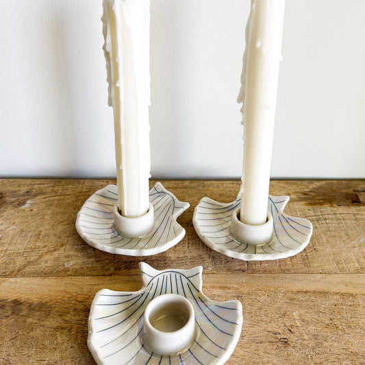 Each candle holder is hand-thrown from fine porcelain, and features hand drawn inlay and mother of pearl luster for a delicate and iridescent shine.