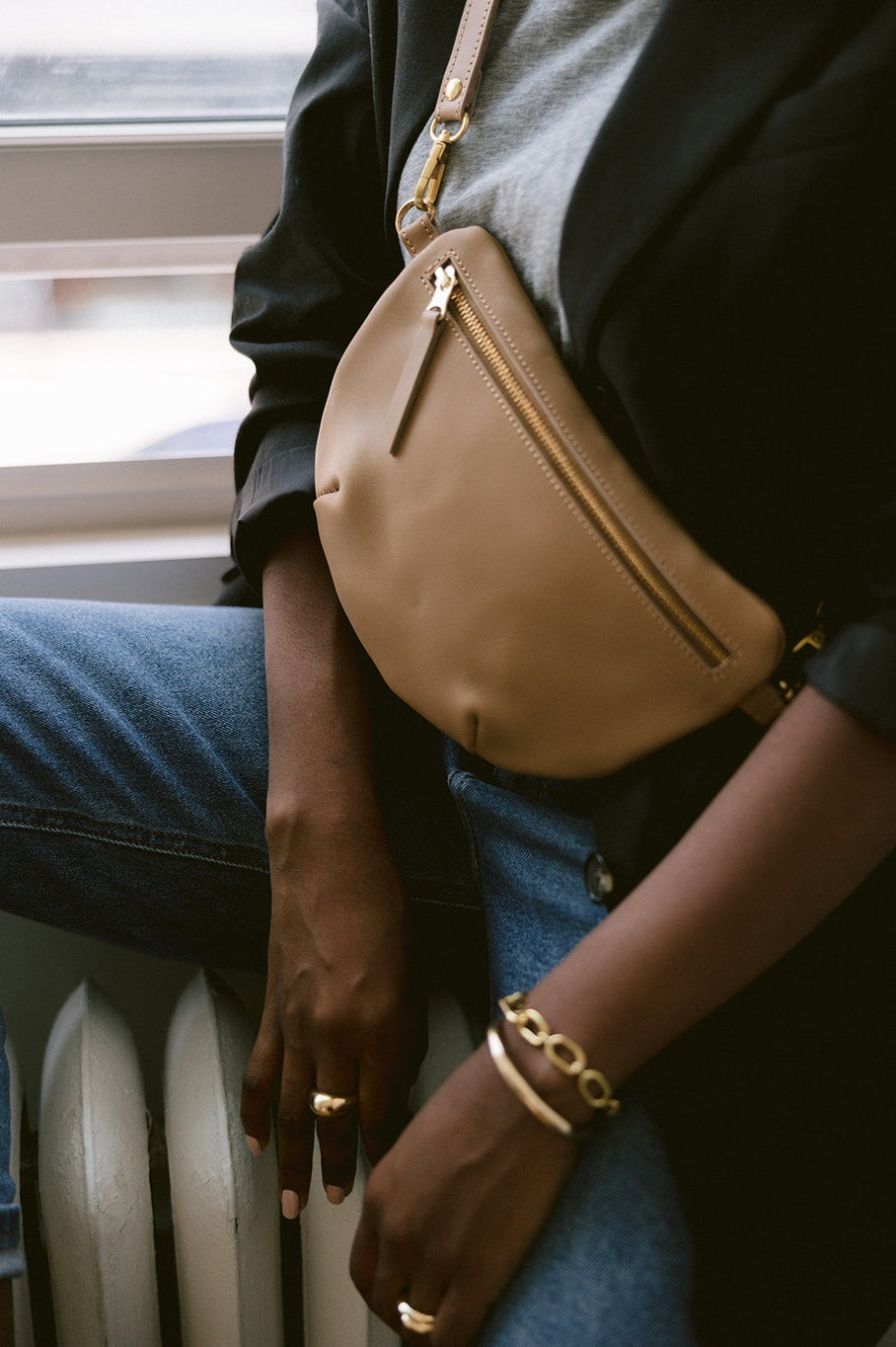 Fair trade and adjustable leather sling bag/fanny pack. Adjust the length to fit your needs. Handcrafted, vegetable tanned leather sling bag made in Kenya with locally and ethically-sourced materials. A portion of sales go to an organization in Tanzania empowering children living on the street.