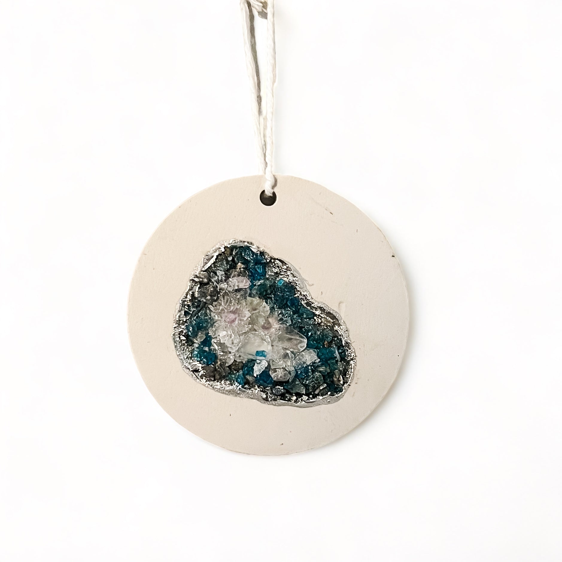 Stunning heirloom ornament whether it’s for your tree or decor for all year. Made from natural blue apatite, celestite, and smoky quartz crystals and outlined in silver chrome leaf.