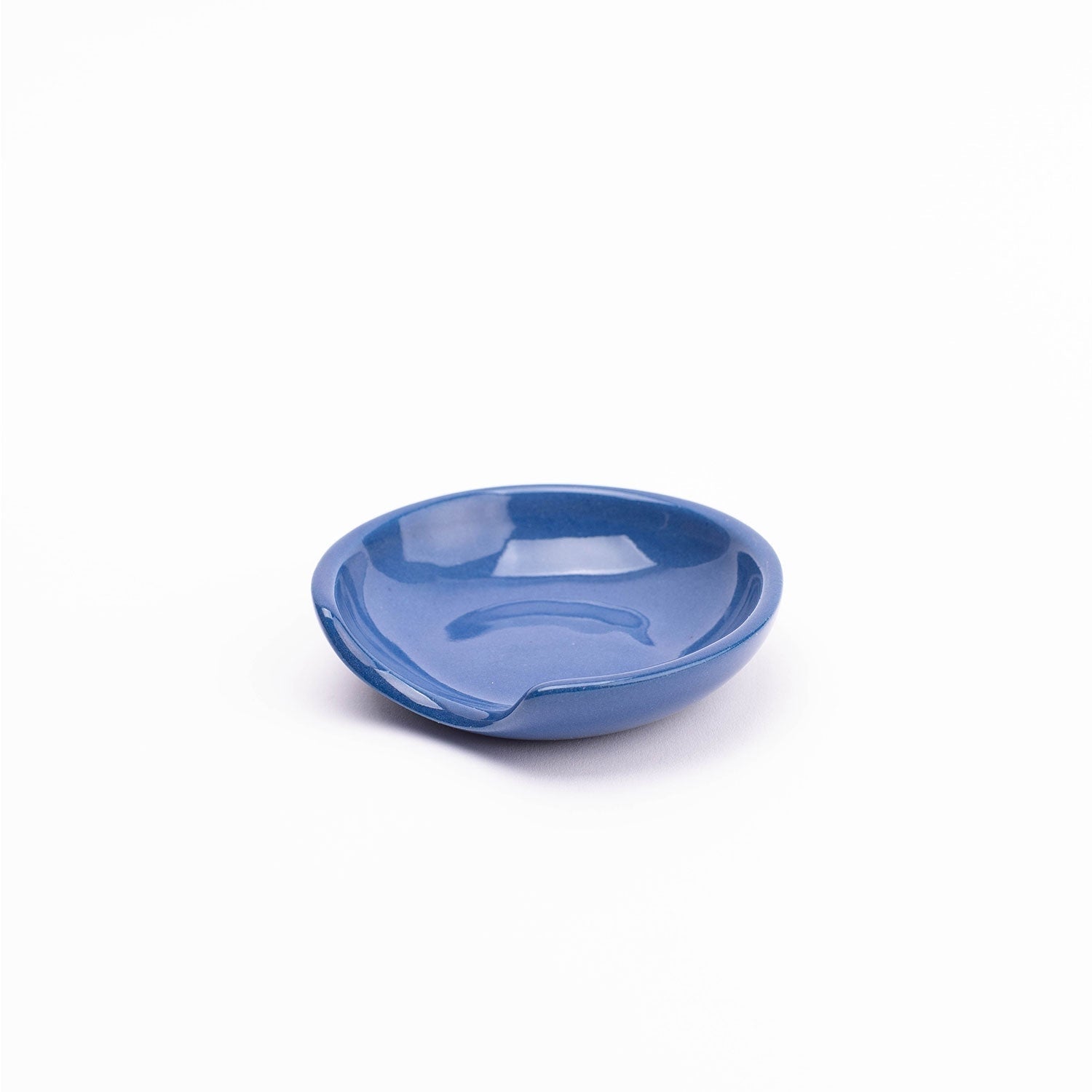  

A handmade stoneware spoon rest with a unique cut-out side perfectly cradles all shapes and sizes of kitchen tools with minimalist flair.
 