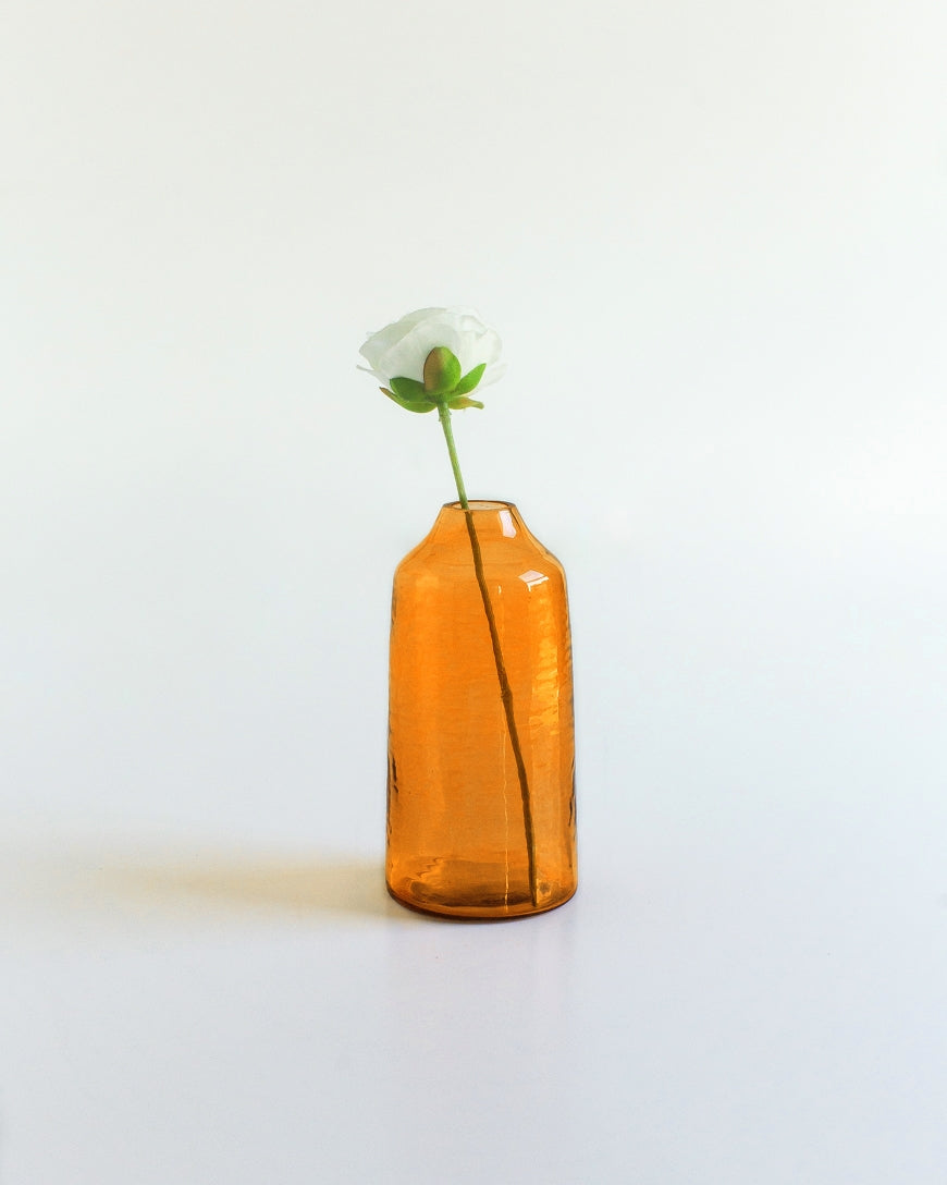 sienna hammered glass bud vase . Ideal for showcasing a single bloom or a small bouquet, these bud vases bring a touch of subtle texture to any space while honoring a commitment to people and the planet.