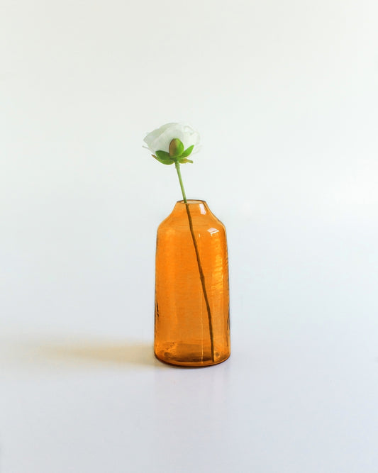 sienna hammered glass bud vase . Ideal for showcasing a single bloom or a small bouquet, these bud vases bring a touch of subtle texture to any space while honoring a commitment to people and the planet.