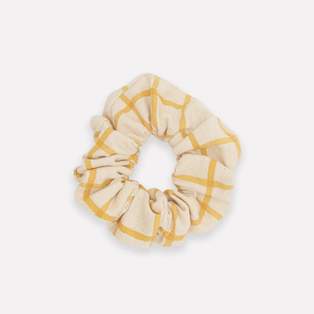 Express yourself with a unique and zero-waste hair accessory that celebrates responsible fashion. Made from organic cotton block print table linen remnents, this eco-friendly scrunchie makes a bold statement and is sure to add the perfect finishing touch to any outfit. 
