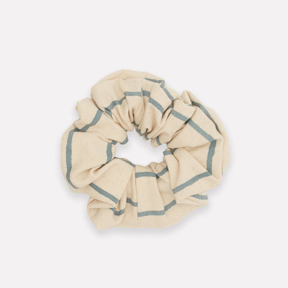 Express yourself with a unique and zero-waste hair accessory that celebrates responsible fashion. Made from organic cotton block print table linen remnents, this eco-friendly scrunchie makes a bold statement and is sure to add the perfect finishing touch to any outfit. 
