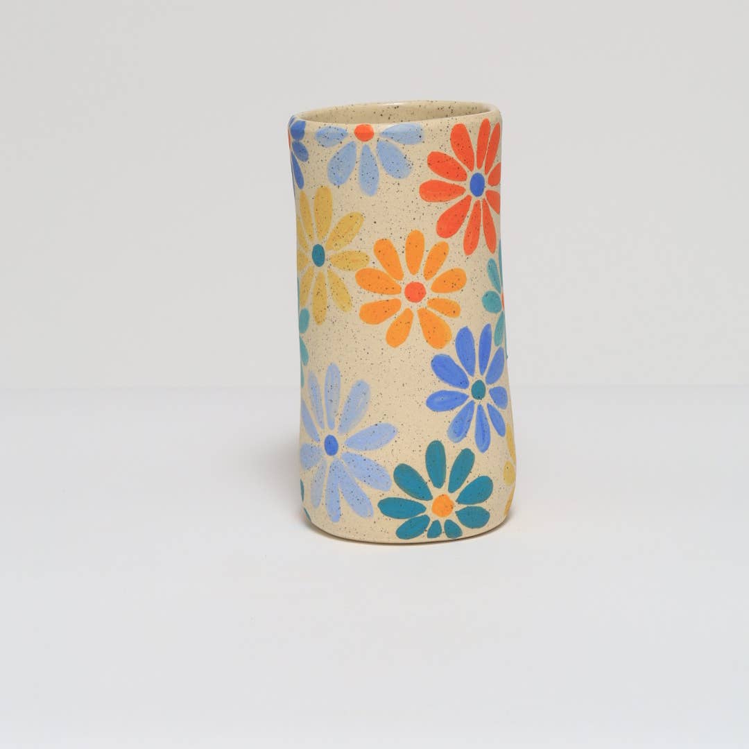 Handmade ceramic vase featuring a colorful hand painted flower design.