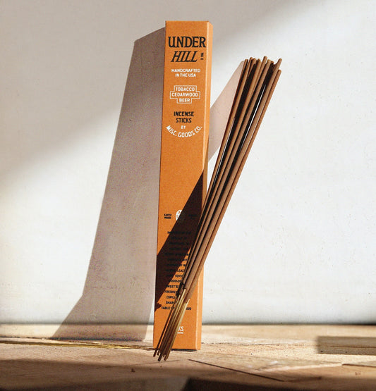 Woods, wild herbs, and worn leather. Underhill Incense Sticks fill your space with the deep, earthy scent of the outdoors — inspired by long walks through forest paths and the quiet richness of fall.

Crafted from a blend of 14 premium oils, it carries notes of rosemary, athelas, pipe tobacco, leather, open air, and freshly poured ale.