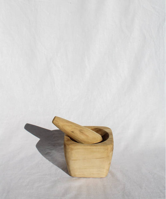 Hand-carved mortar and pestle in a small town named Liquine surrounded by the Andes Mountains, volcanoes, and lakes in the south of Chile. Wood Carving in the South of Chile is one of the most traditional manifestations of the indigenous Mapuche people where they use native fallen wood from the forests.