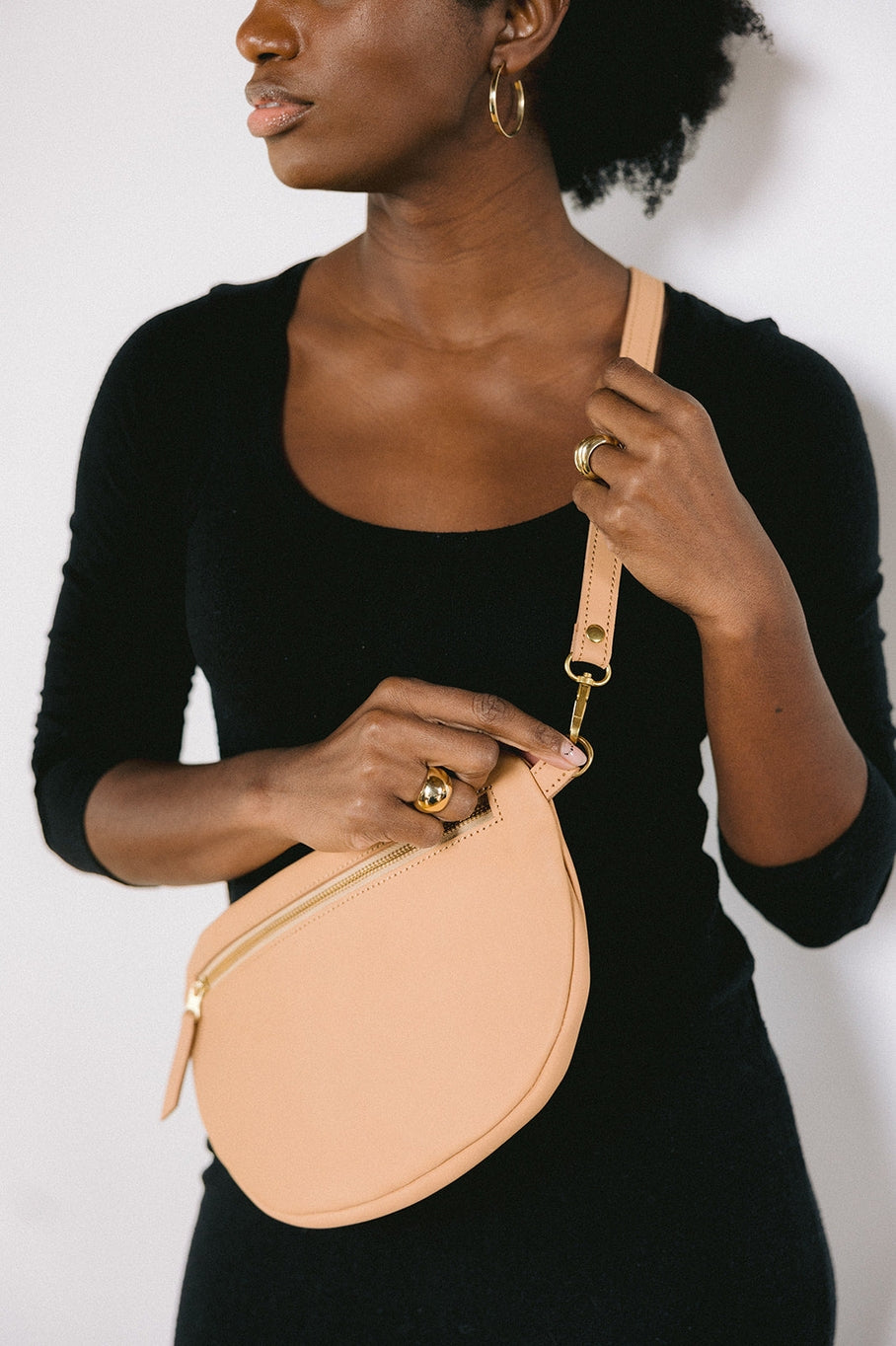 The best-selling Sling Bag is now available in a bigger size. Still sleek, lightweight, and chic, now you'll be able to add that *one* extra thing. Your large wallet, glasses case, or even a small book will fit inside the Big Sling. Fair trade and adjustable leather sling bag/fanny pack.