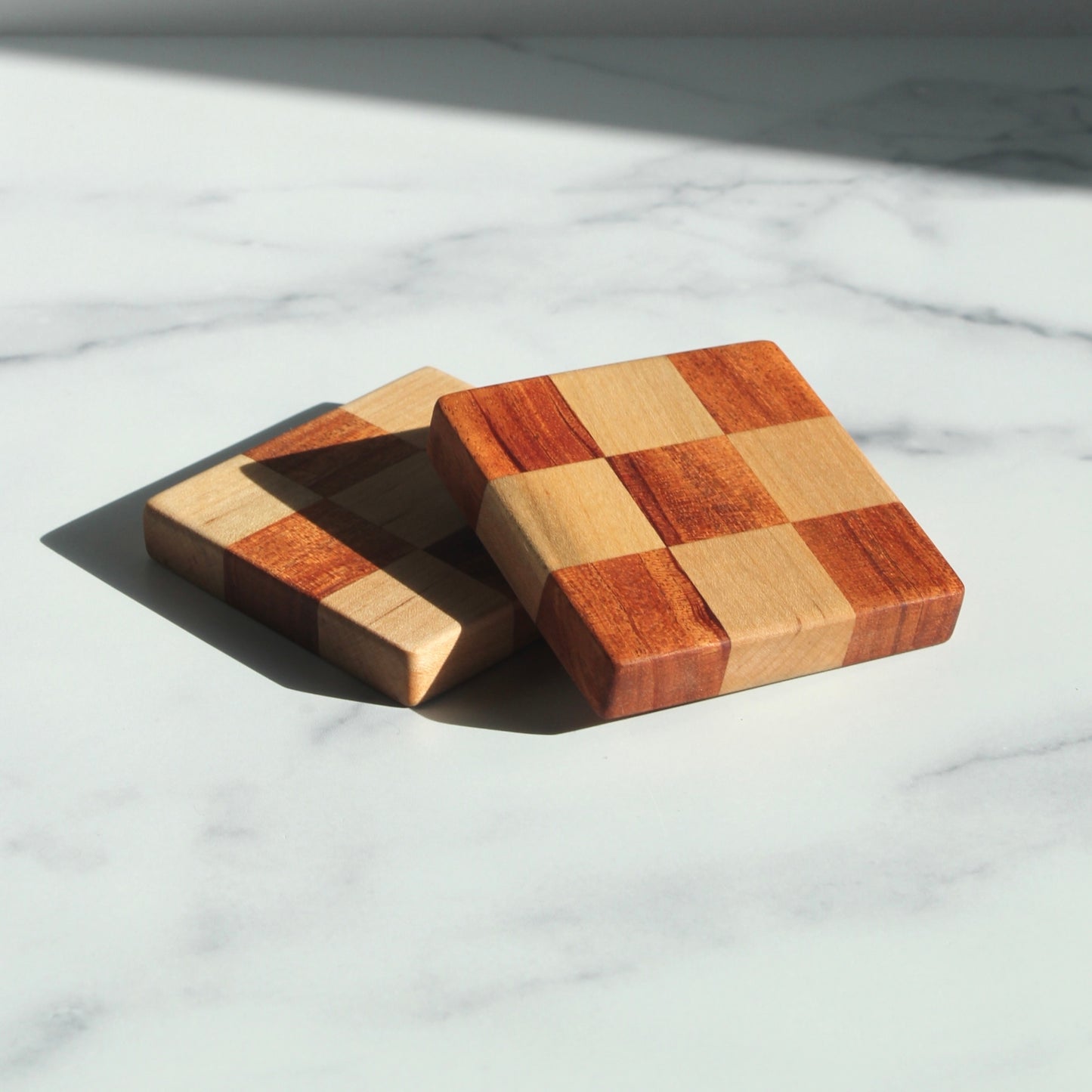 The Chelsea Handcrafted Jumbo Wood Coaster Set offers a unique spin on a traditional checkered design, with a bulkier size that makes them perfect for unconventional spaces where you still want to protect your furniture, like your office or bedroom.&nbsp;