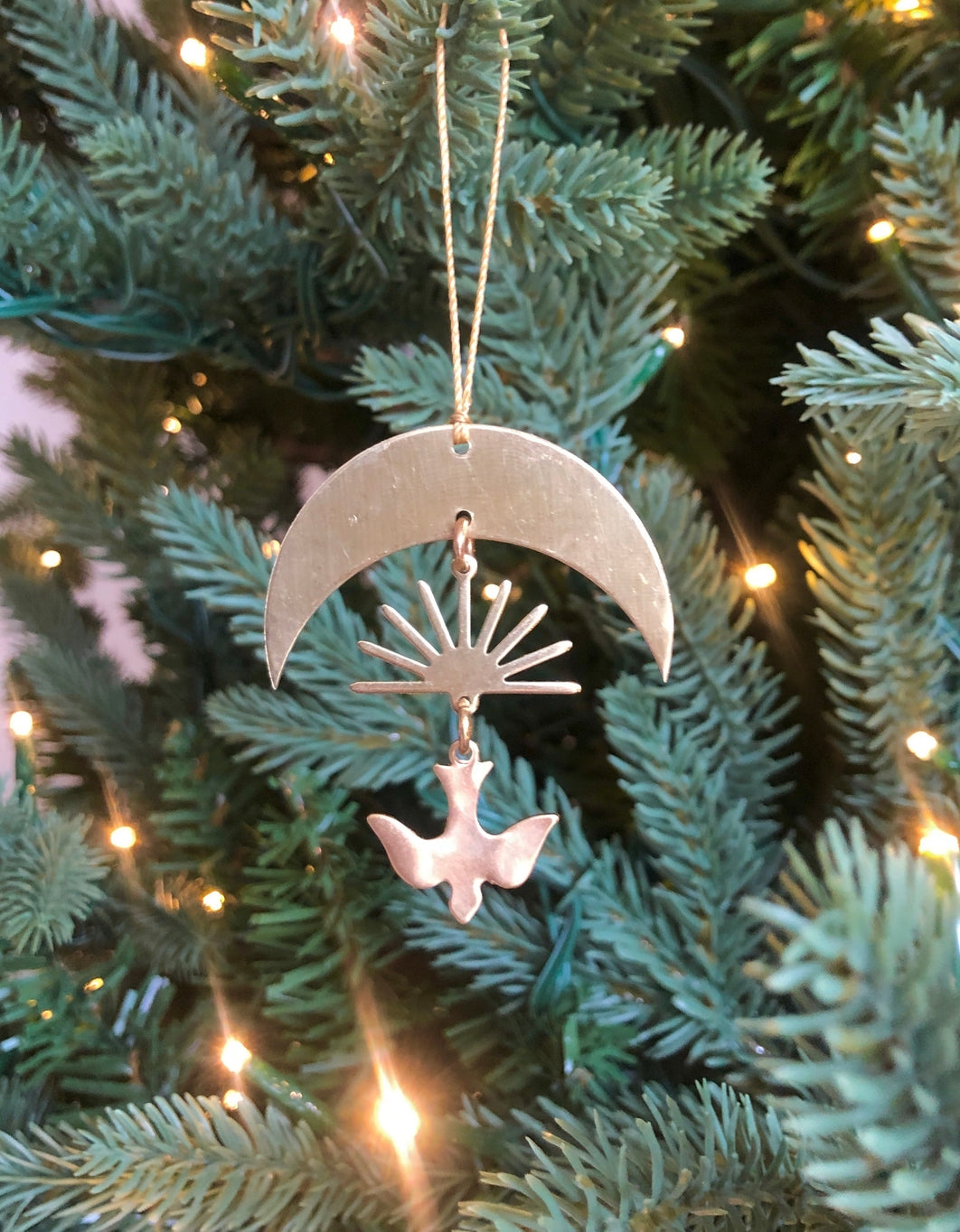 Artisan-crafted story ornament made from hand-cut/hammered brass sheet. Ready to hang.Ornament measures roughly 3” tall not including hanging twine.