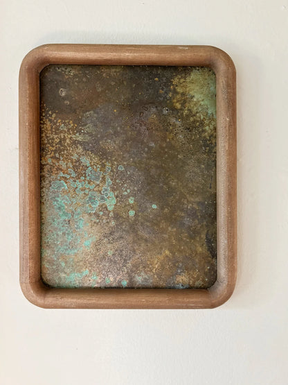 Rust-colored patinated brass sheet set in a rounded wood frame. by electric sun creatives sarah perez