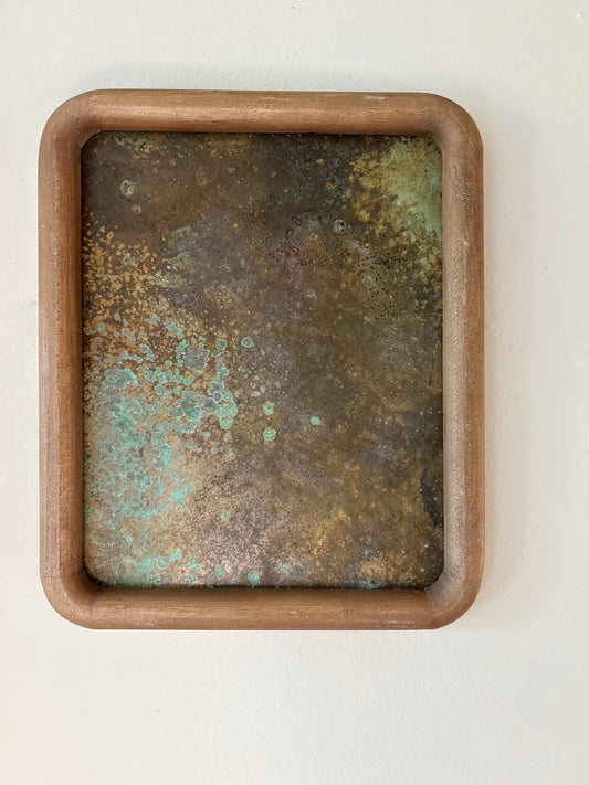 Rust-colored patinated brass sheet set in a rounded wood frame. by electric sun creatives sarah perez
