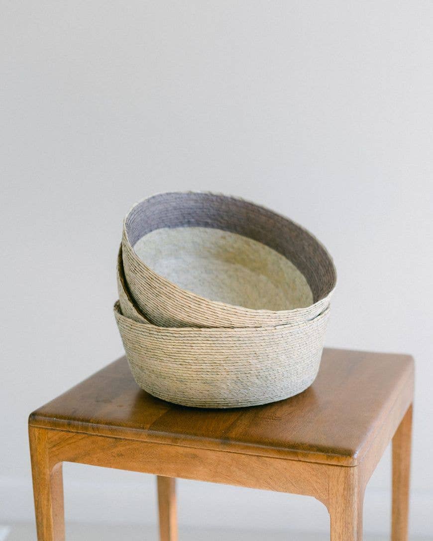 In the mountains of Southern Mexico, artisans weave these exquisite baskets from sun-dried palm leaves. Each takes days to complete using traditional skills passed down through generations. This versatile design pairs the beautiful hues of natural fiber with a block of subtle earthy color.