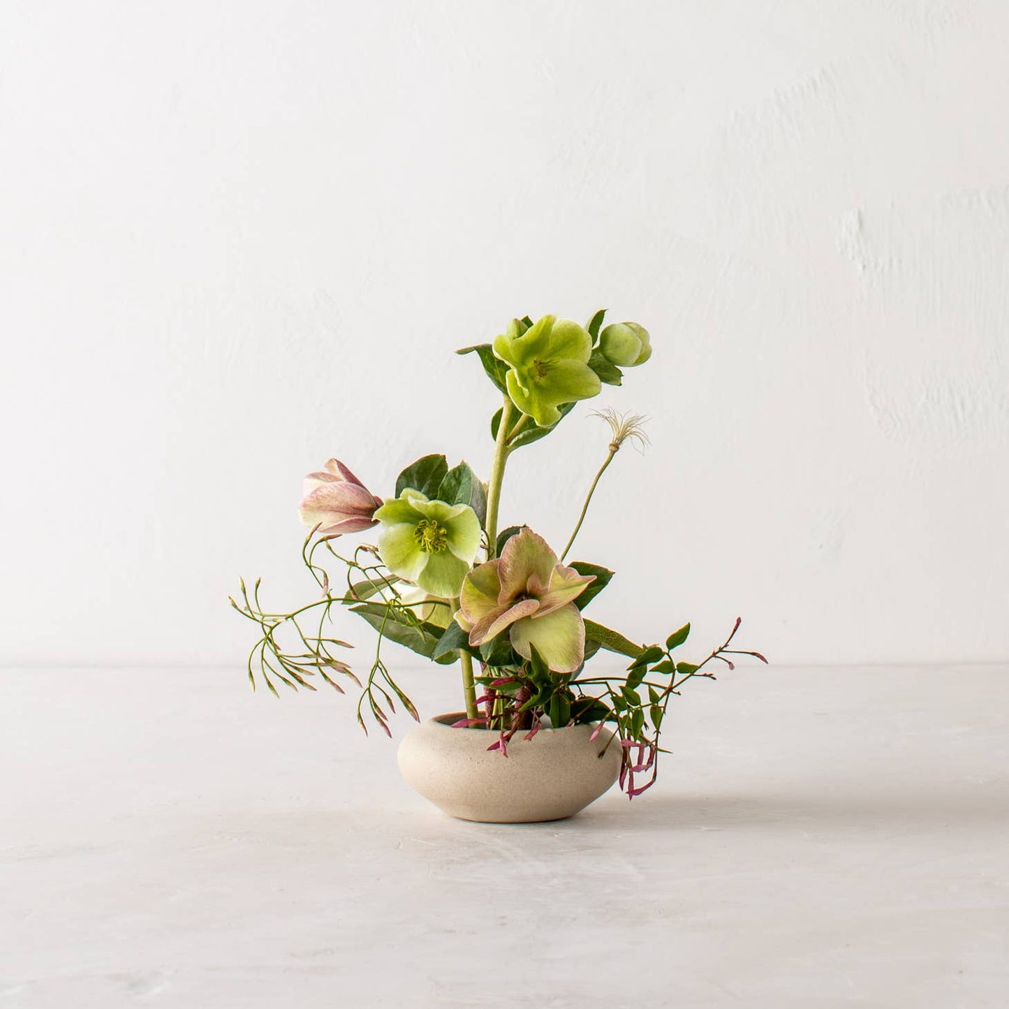 convivial ikebana vase no 1 / Slow down and enjoy the subtle beauty of nature with a handmade ceramic ikebana vase. This round, shallow vase is designed for minimal, ikebana inspired arrangements. Handmade with proprietary sandstone with an ivory glaze on the interior.