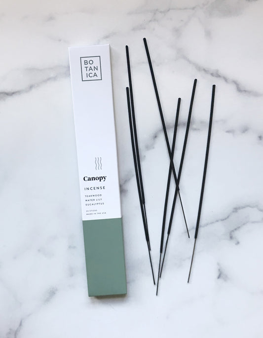 botanica canopy incense. Made with high-quality fragrance blends, plus essential oils for a long, balanced ritualistic experience–sure to make any dwelling feel like a luxurious retreat. Scent notes of teakwood, water lily, and eucalyptus.