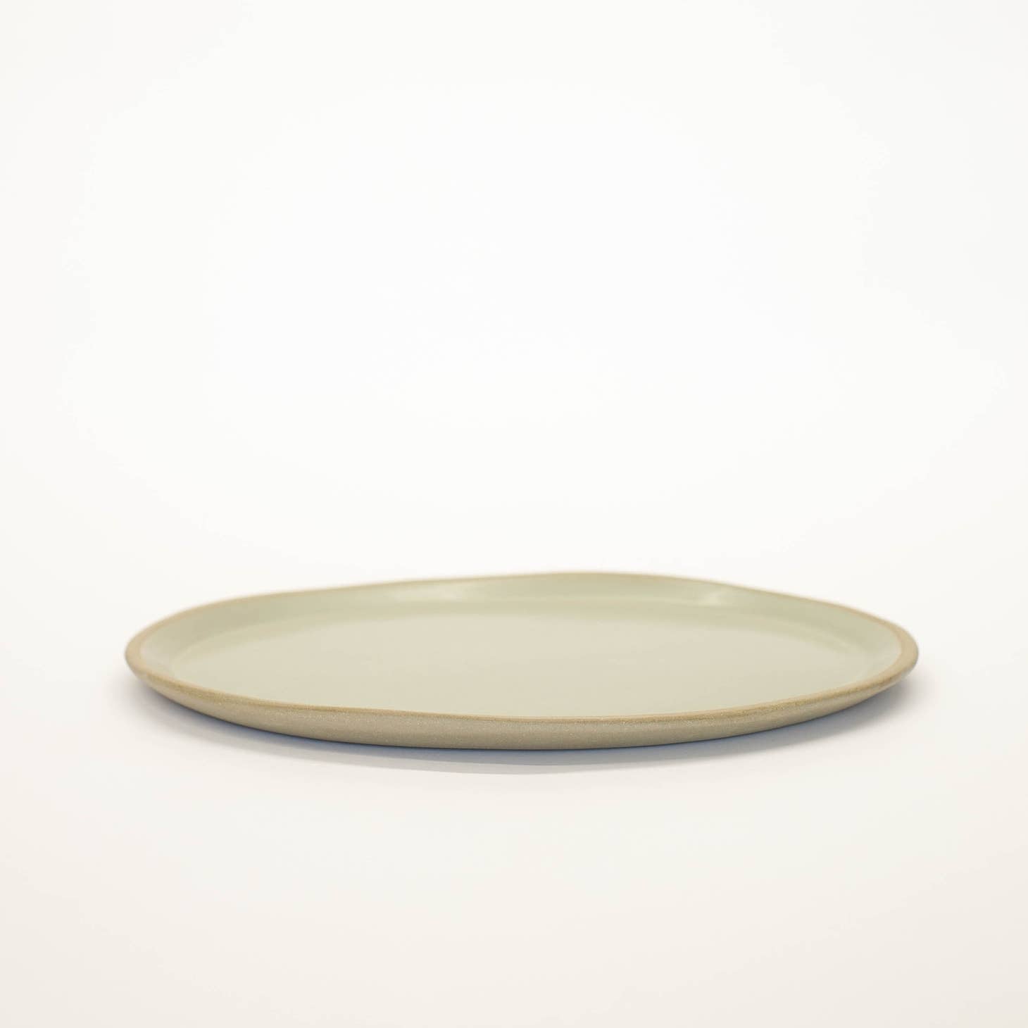 Hand-built with shallow walls, some organic quality around the rim, and a flat base, this ceramic platter is designed for serving. Use it as a charcuterie board, snack platter, coffee table tray, or your main course!  Handmade in Virginia