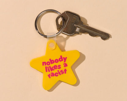 "Nobody Likes A Racist" yellow stair keychain. Made from PVC.