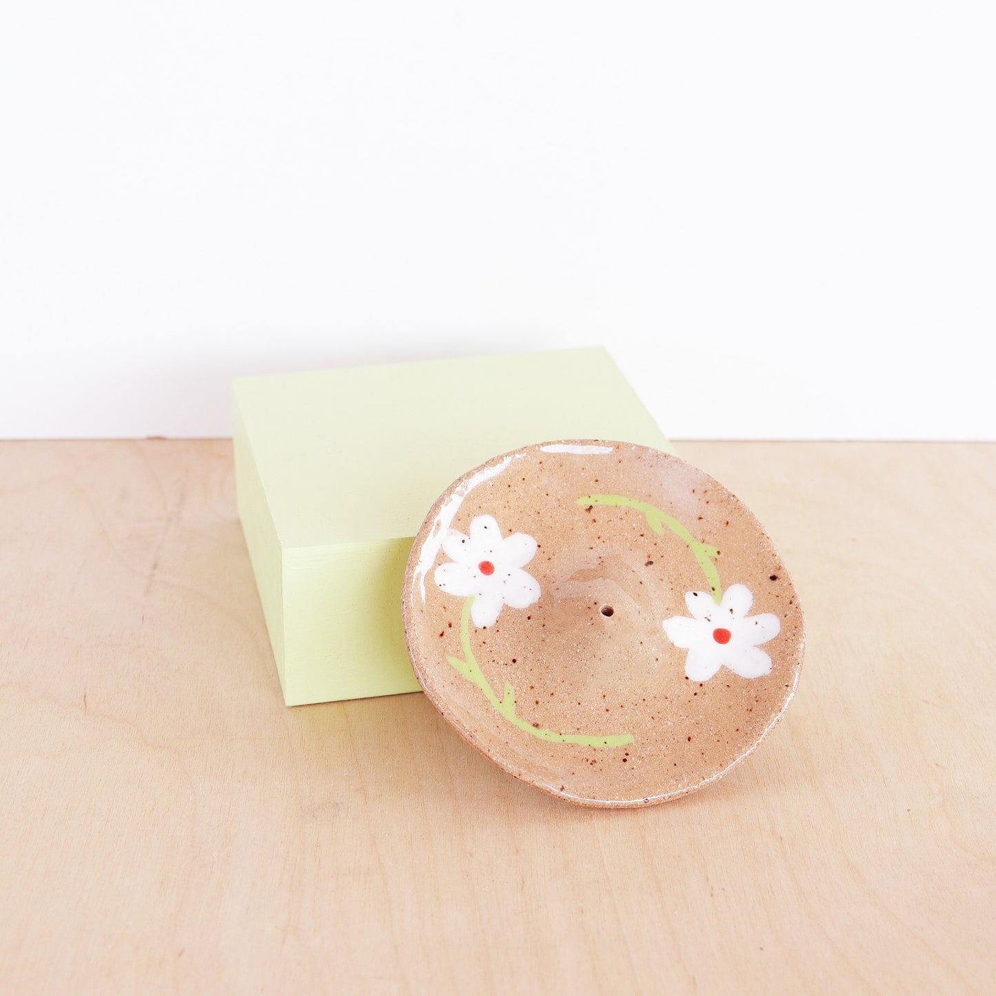 nightshift ceramics - Modern, minimalist incense holder. Hand formed from speckled stoneware and finished with daisy illustration and clear glaze.