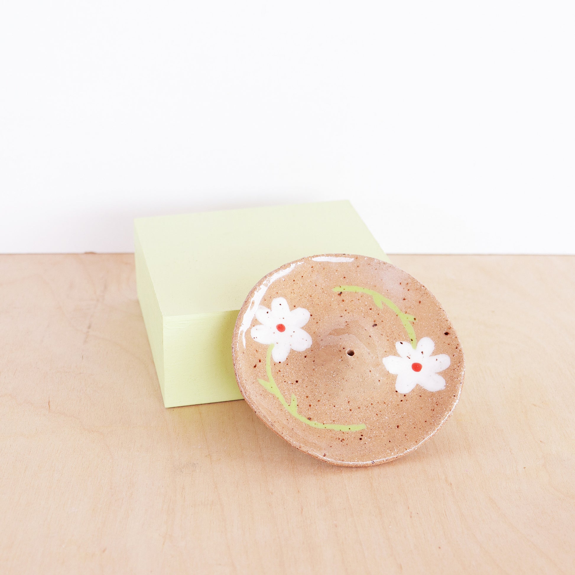 nightshift ceramics - Modern, minimalist incense holder. Hand formed from speckled stoneware and finished with daisy illustration and clear glaze.