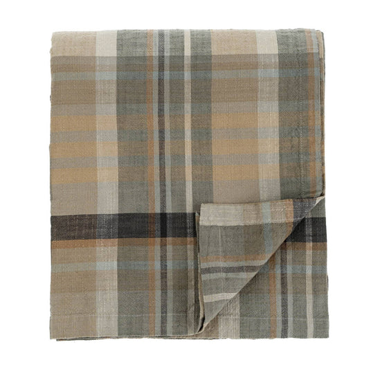Folded plaid tablecloth/light blanket with earthy tones for your holiday table.