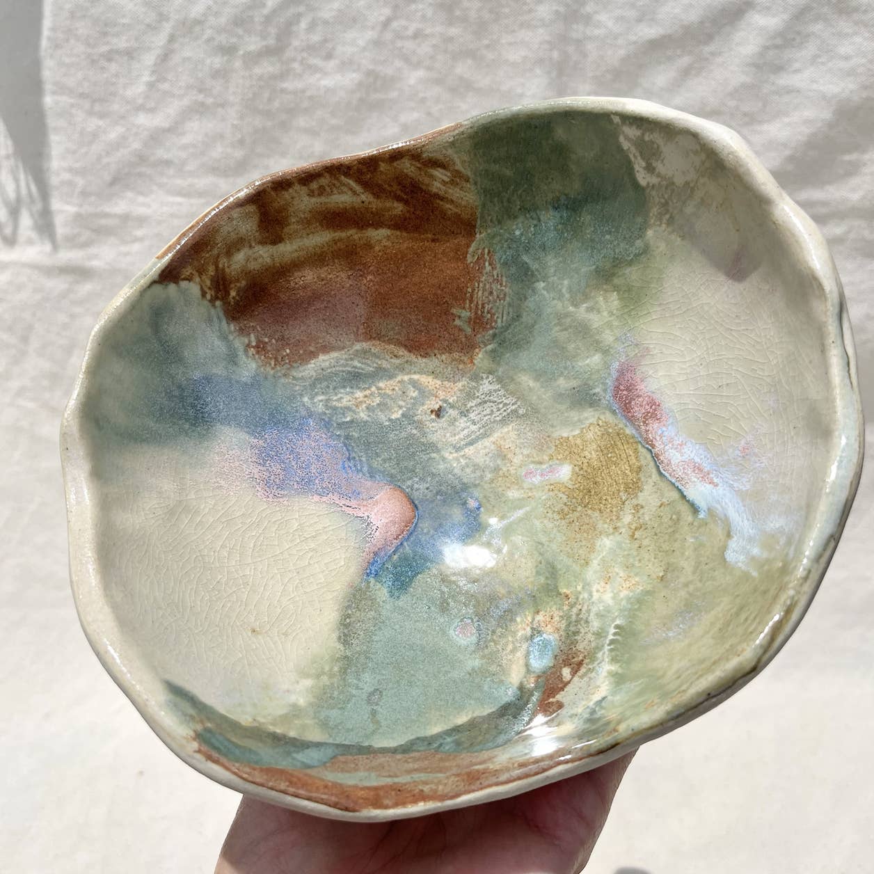 Heavy footed dish made from white clay with a variety of glazes. For your fruit, your jewelry, candles, shared food dish, whatever! Hand built, glazed and fired in San Luis Obispo  by Roaming Barefoot Ceramics.