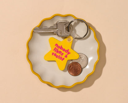"Nobody Likes A Racist" yellow stair keychain. Made from PVC.