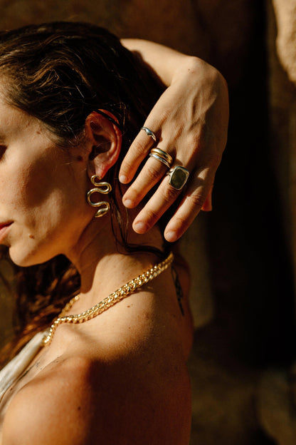 An often maligned species, we find beauty in the powerful serpent. Asymmetrical snake earrings available in brass and sterling silver. All Dea Dia pieces are proudly designed and handmade in Downtown Los Angeles.