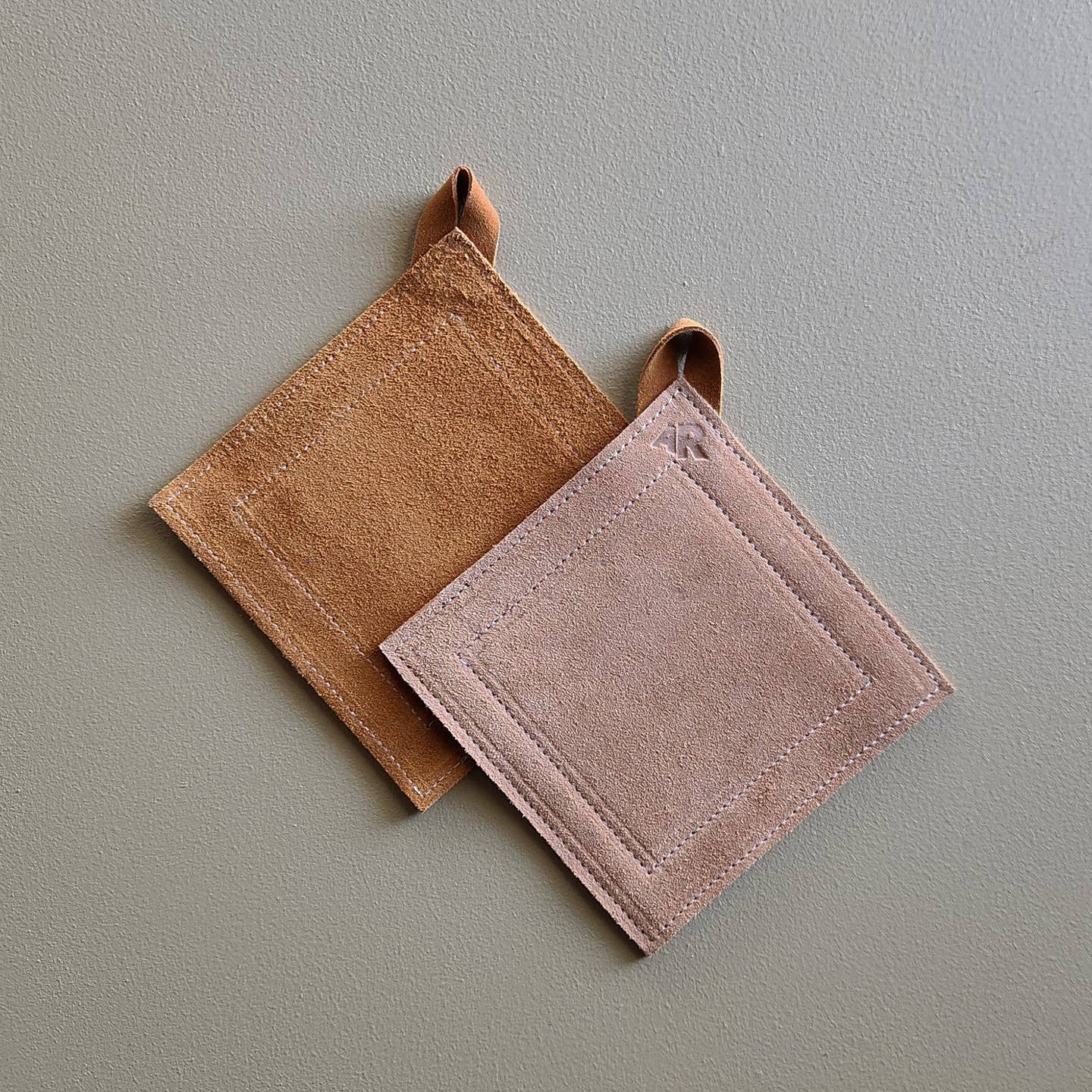 Double-sided suede potholder with loop.