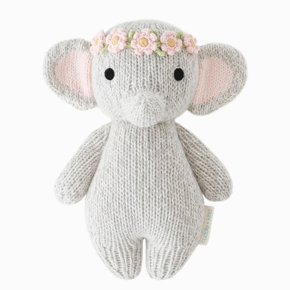 Knitted elephant toy with a flower crown on a white background. Absolutely adorable and oh so collectible! At an endearing 7” tall, our lovingly hand-knit baby animals are made with natural 100% cotton yarn and perfectly sized for little hands to grab and hold.

Every baby animal purchased provides 5 meals to children in need and empowers artisans in Peru and Nepal with fair trade income.