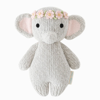 Knitted elephant toy with a flower crown on a white background. Absolutely adorable and oh so collectible! At an endearing 7” tall, our lovingly hand-knit baby animals are made with natural 100% cotton yarn and perfectly sized for little hands to grab and hold.

Every baby animal purchased provides 5 meals to children in need and empowers artisans in Peru and Nepal with fair trade income.