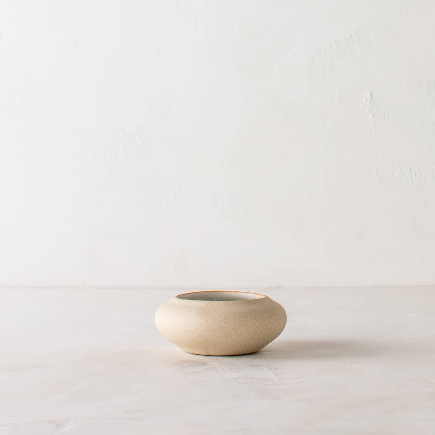 convivial ikebana no 2 vase / Slow down and enjoy the subtle beauty of nature with a handmade ceramic ikebana vase. This round, shallow vase is designed for minimal, ikebana inspired arrangements. Handmade with proprietary sandstone with an ivory glaze on the interior.