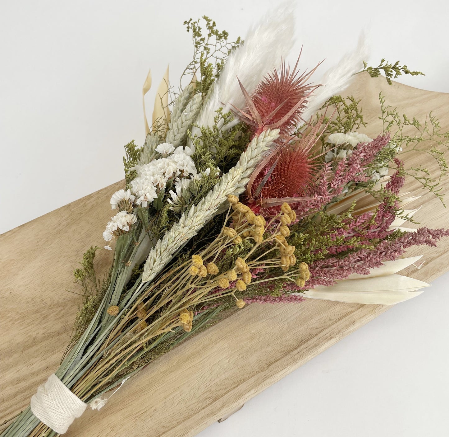 Andaluca’s floral team designed this beautiful bouquet using a mix of wildflowers, grains, bunny tails, and palm leaf to create this lush and opulent bouquet arrangement. 