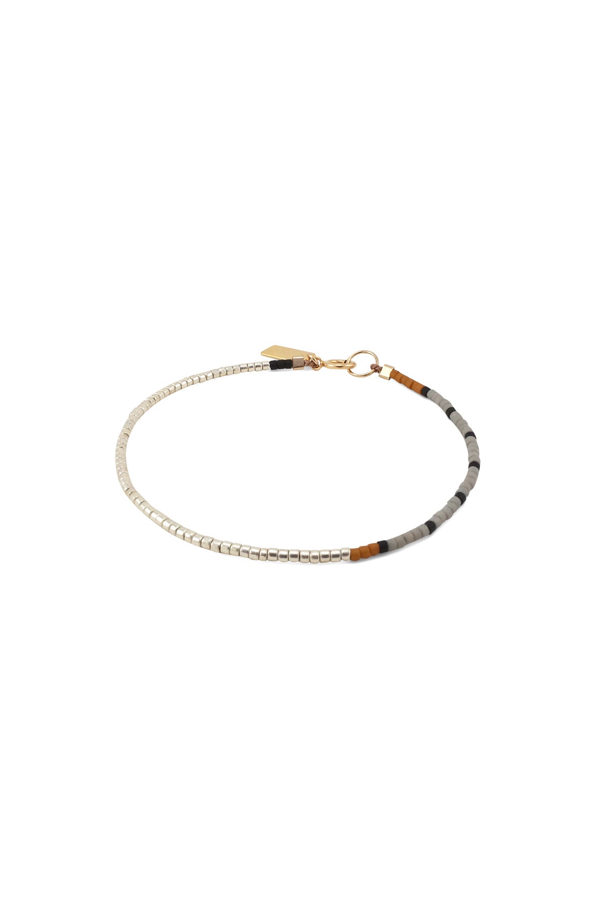 The Nootka Bracelet has an asymmetrical design featuring a long gold beaded segment and a sequence of black beads among a stretch of palette colors.