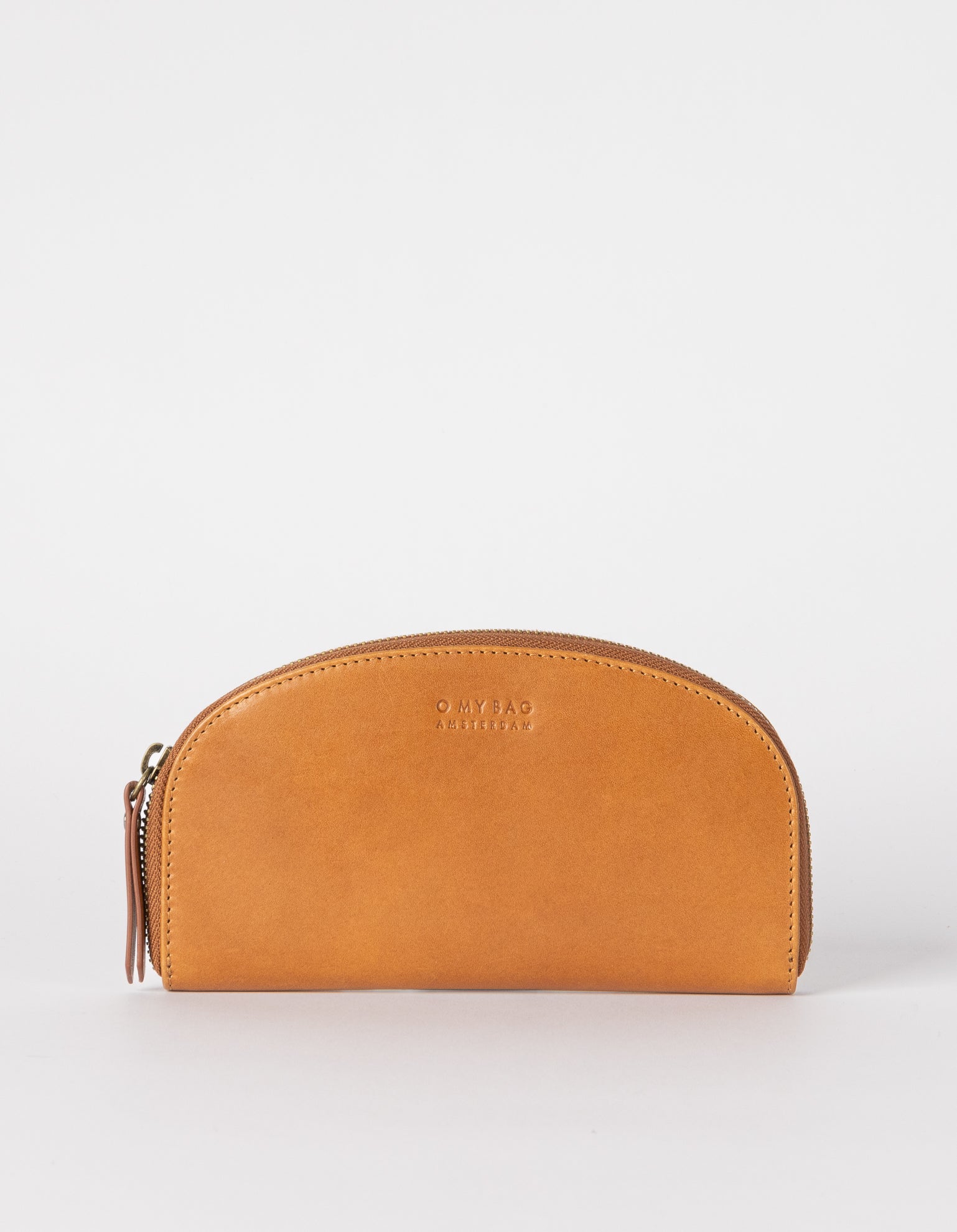 Introducing Blake, the smooth leather rounded wallet that's here to add a touch of chic charm to your everyday essentials. The roomy interior has a zip pocket for coins, eight card slots and two compartments for cash. Ethically made in India.