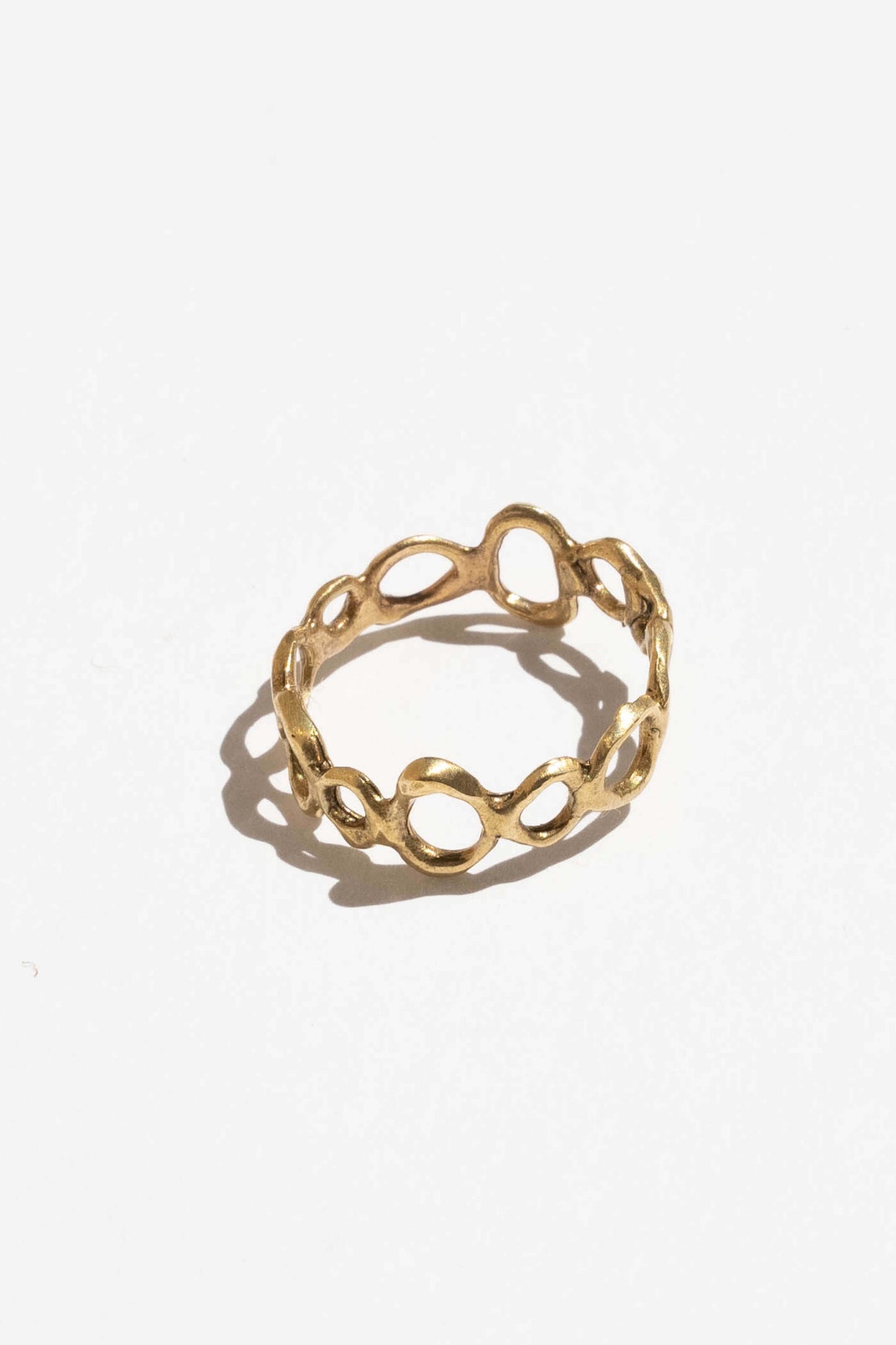 Gold ring with a unique design on a white background. Moneh Brisel Current Ring