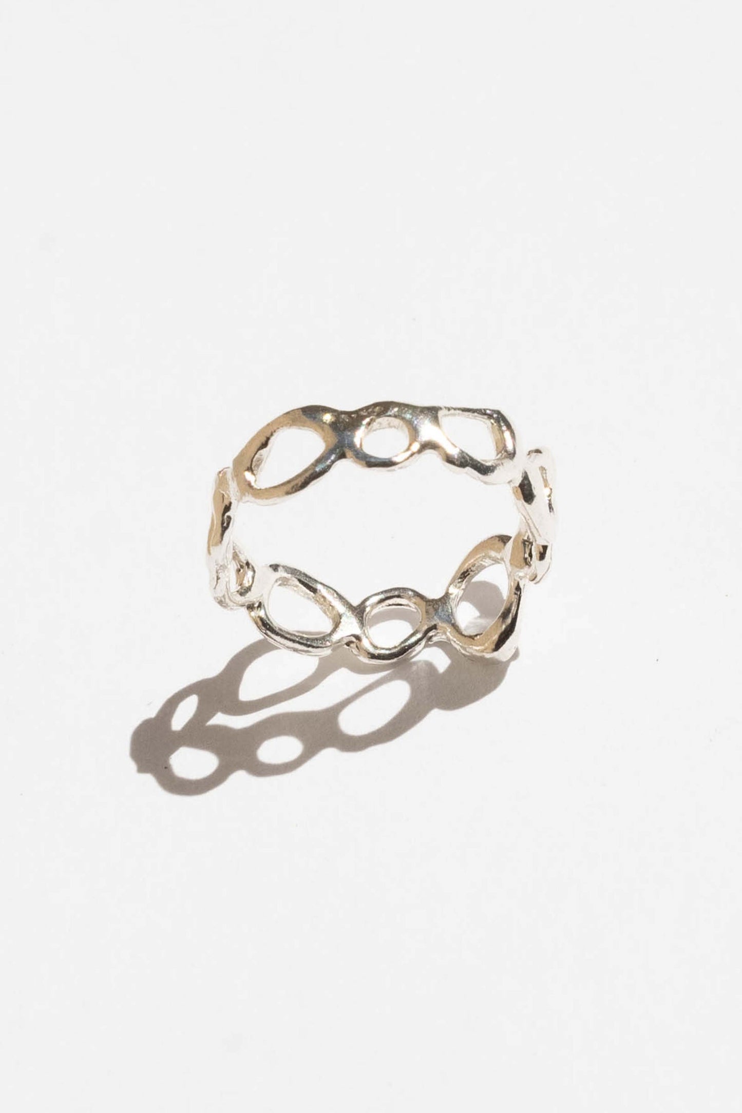 Silver ring with a unique design on a white background. Moneh Brisel Current Ring