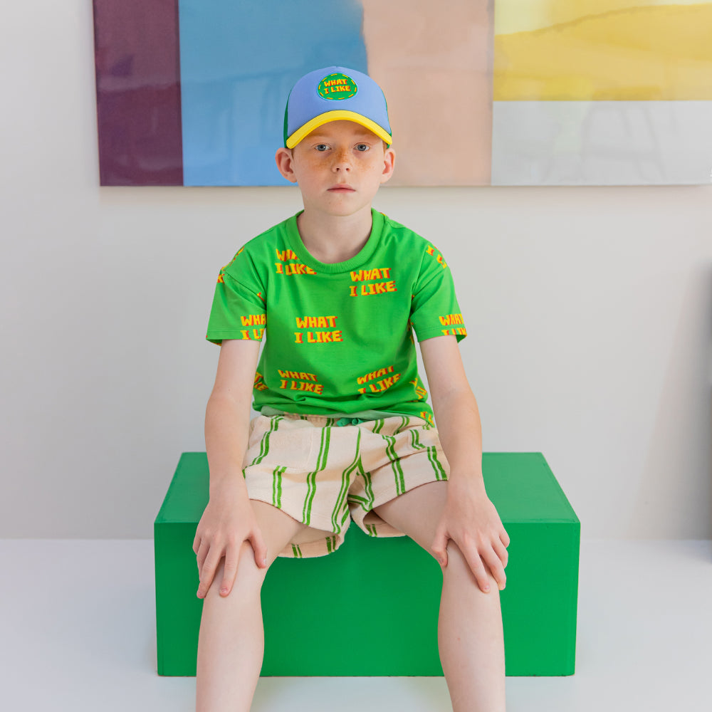 A classic cream short with green stripes. Terry towel fabric provides a loose fit, includes pockets and drawstring waistband.  Ethically produced, colorful and fun with an eye towards comfort, style and joy. Modern and sustainable kids clothing by CarlijnQ of the Netherlands.