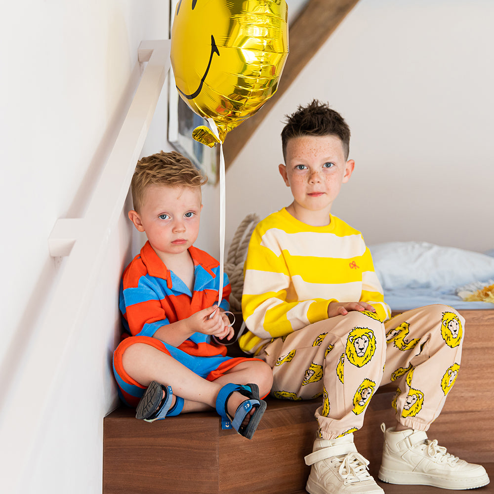 Tan based jogger style sweatpants with a playful lion print.Ethically produced, colorful and fun with an eye towards comfort, style and joy. Modern and sustainable kids clothing by CarlijnQ of the Netherlands.